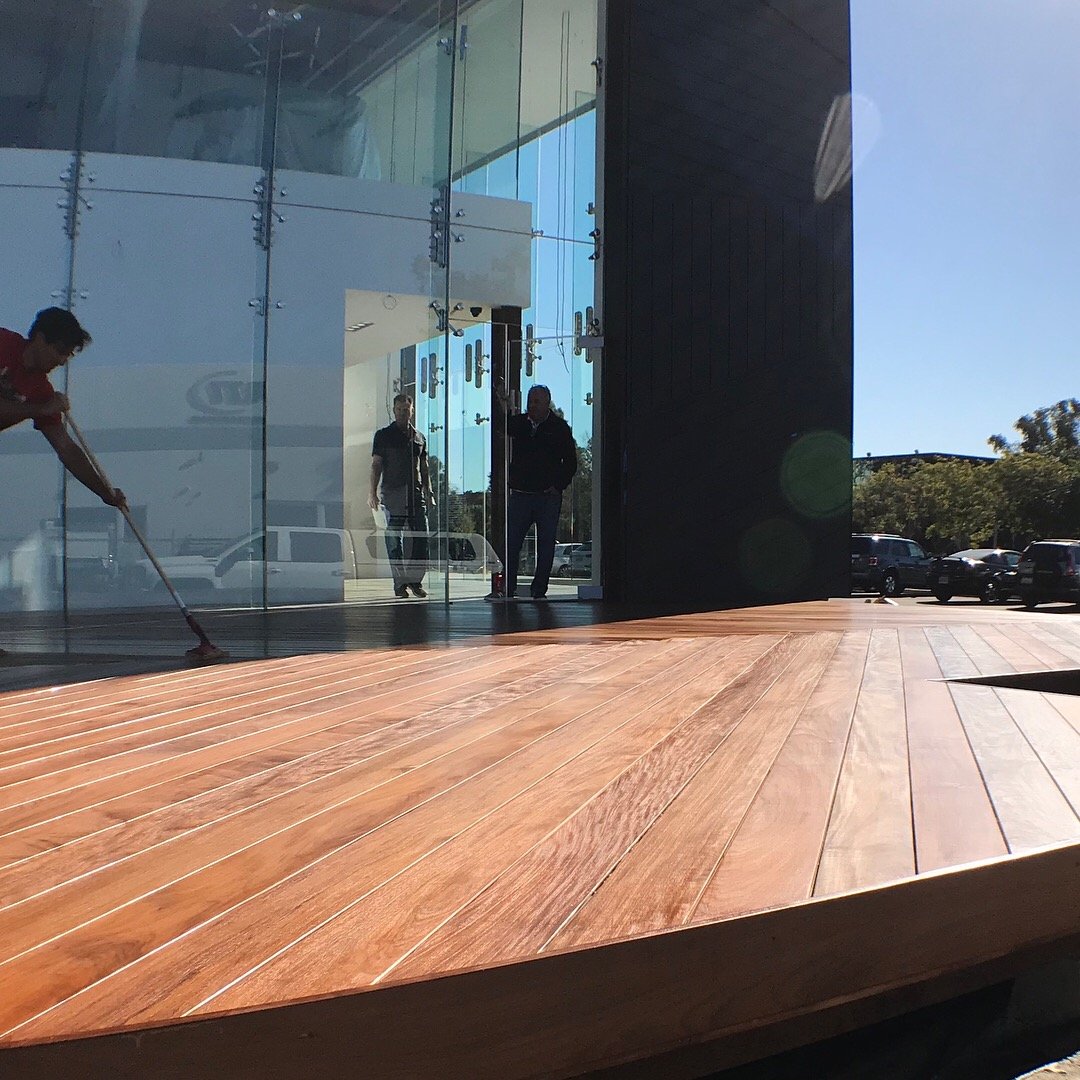 Wood deck and glass storefront construction detail after completion