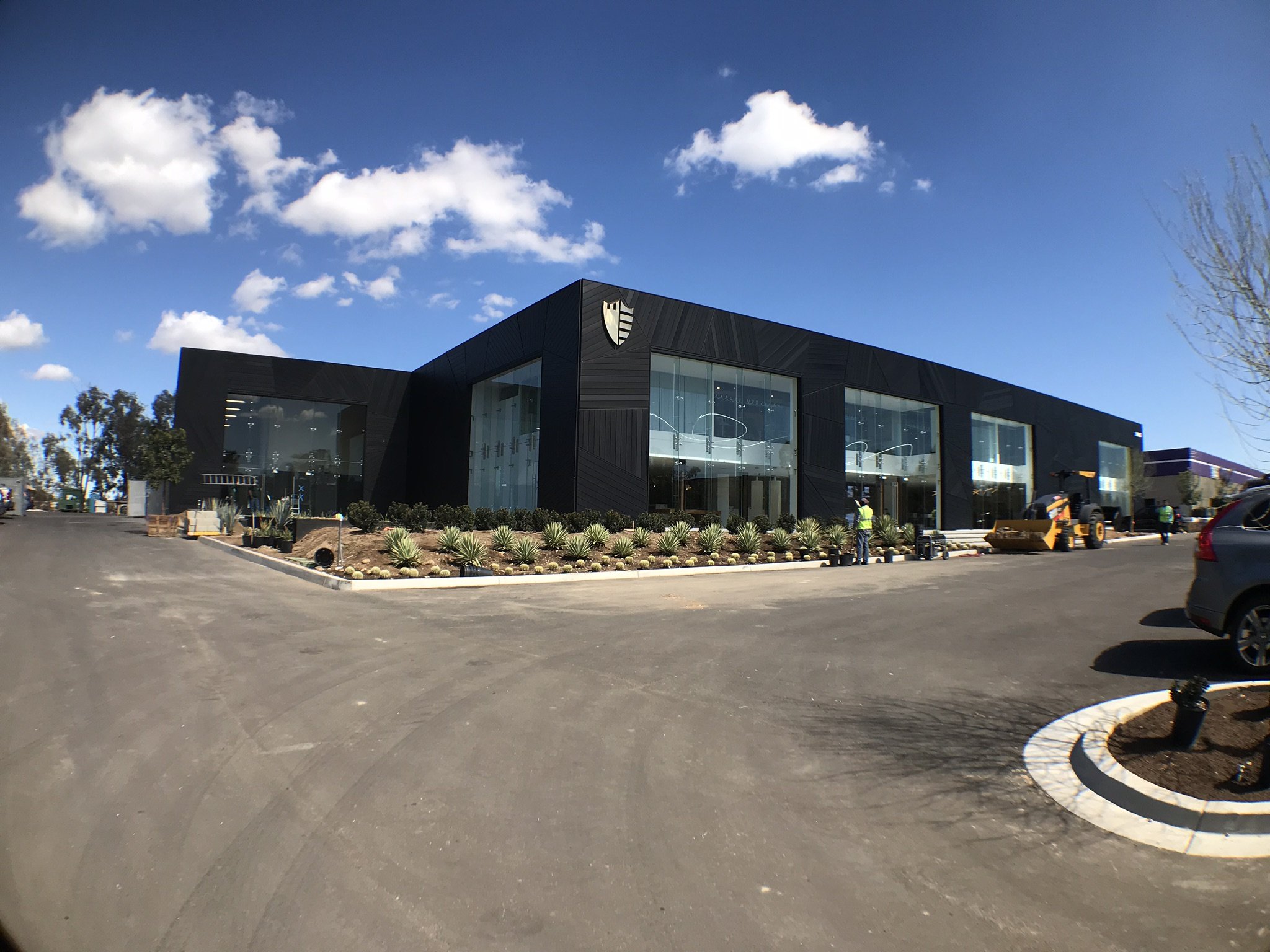 Wide view of the completed commercial building exterior and finished site