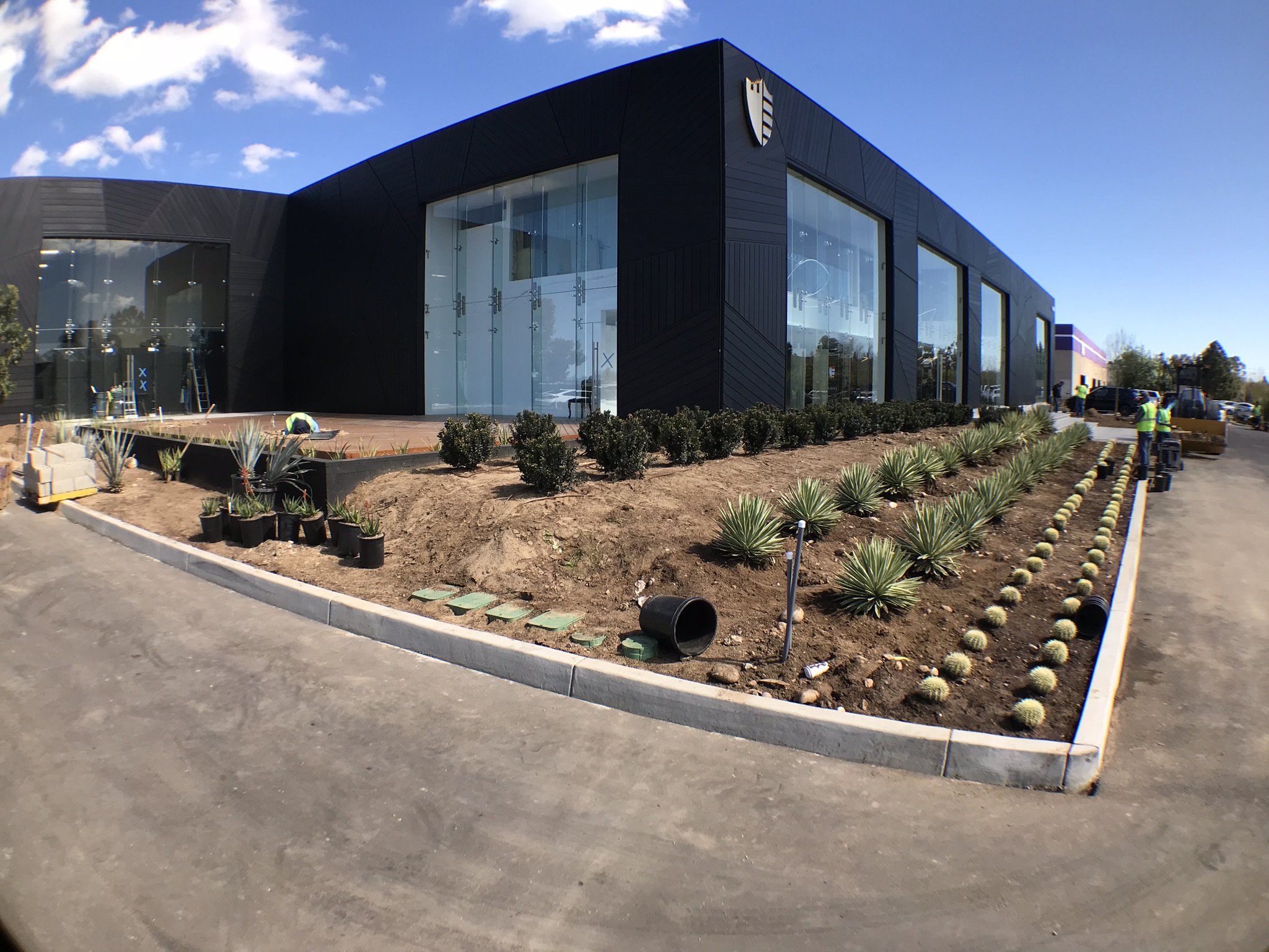 Finished black metal cladding and drought-tolerant landscape edge