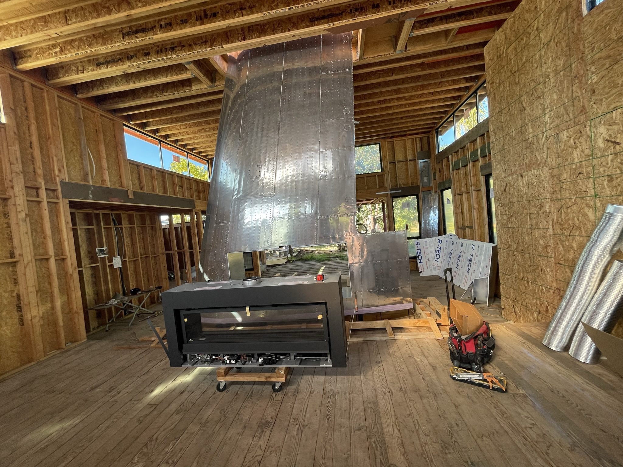 Grandview building process with exposed wood ceiling and custom fireplace feature