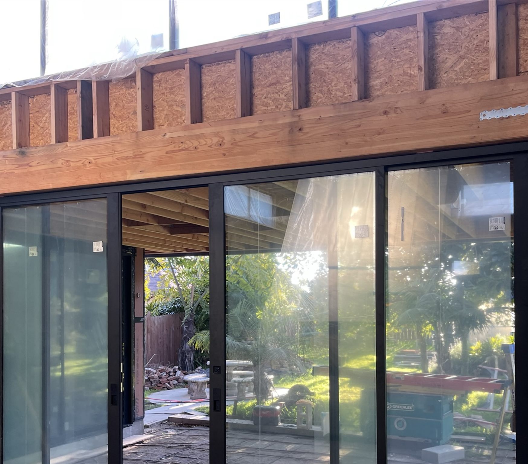 Fleetwood-style glass door wall installation and wood framing detail during Grandview construction
