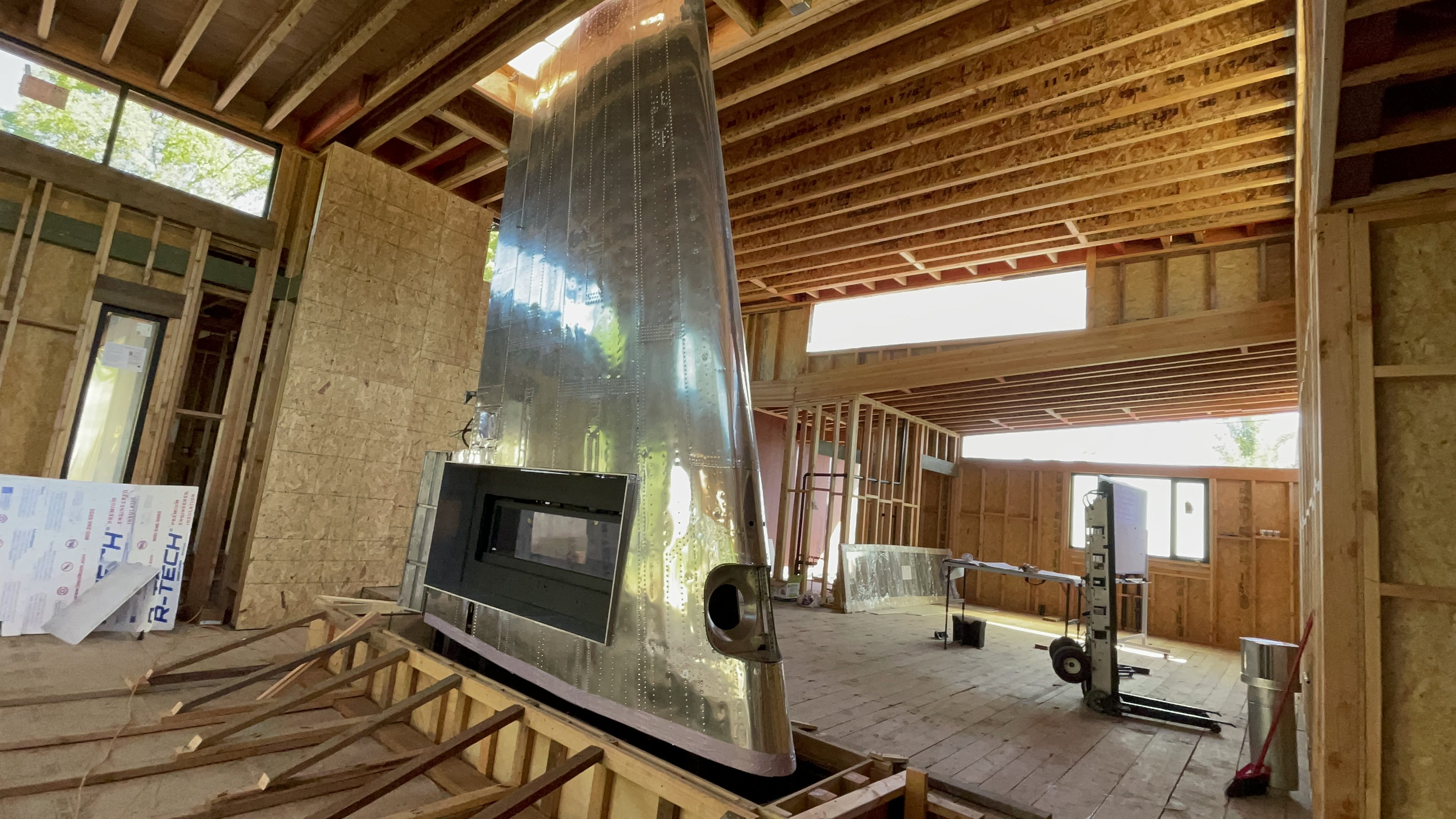 Grandview interior process view showing open framing, high windows, and custom feature coordination