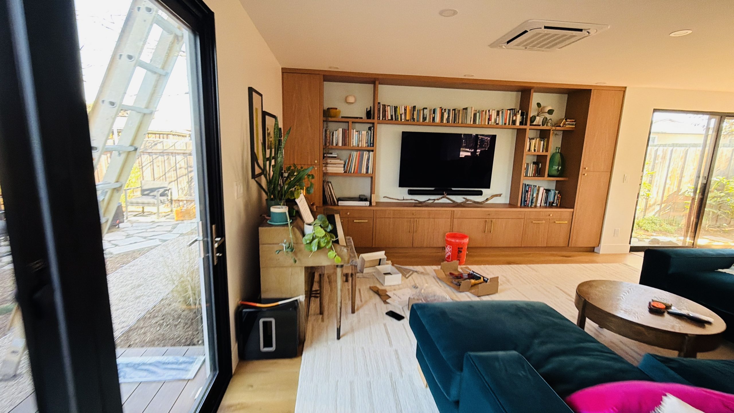 Finished South Oceanside living room with custom media wall and built-in shelving