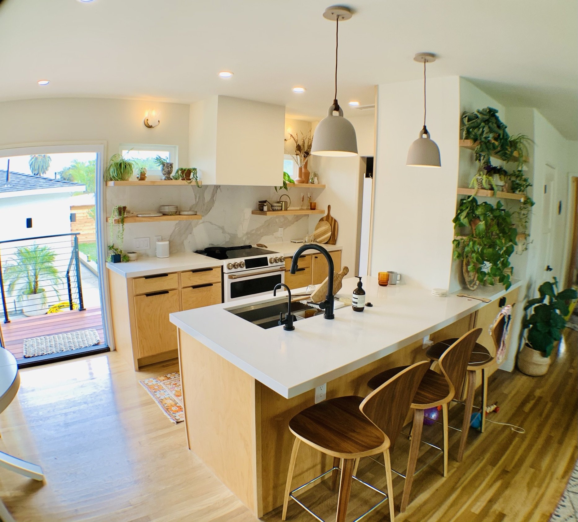 Completed bright kitchen with white cabinetry and updated finishes