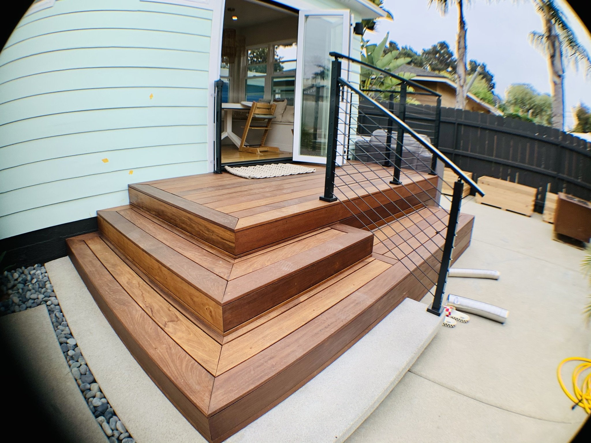 Finished deck stairs, railing, and landscape transition
