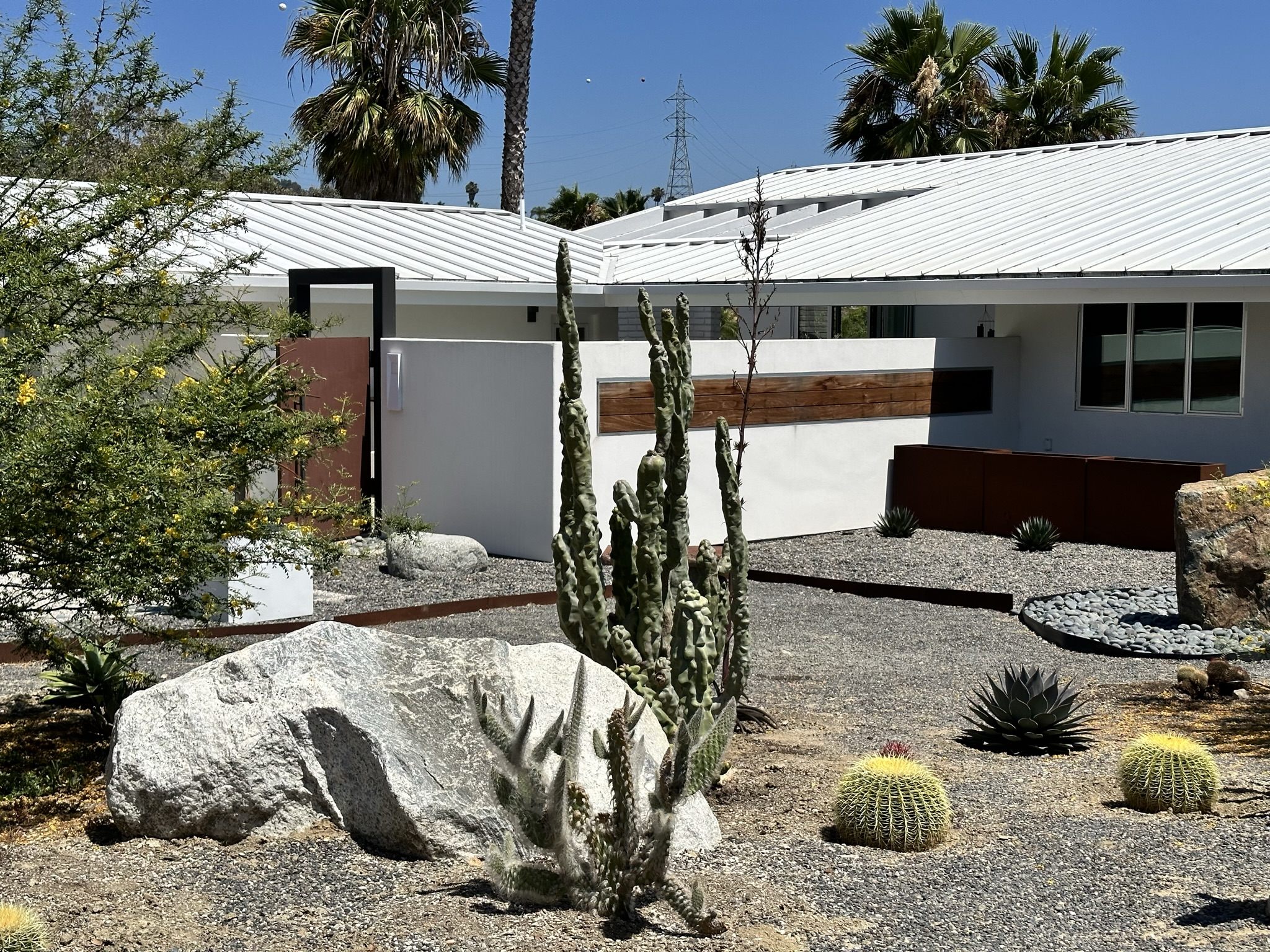 Front exterior and landscape after a residential remodel with clean modern detailing