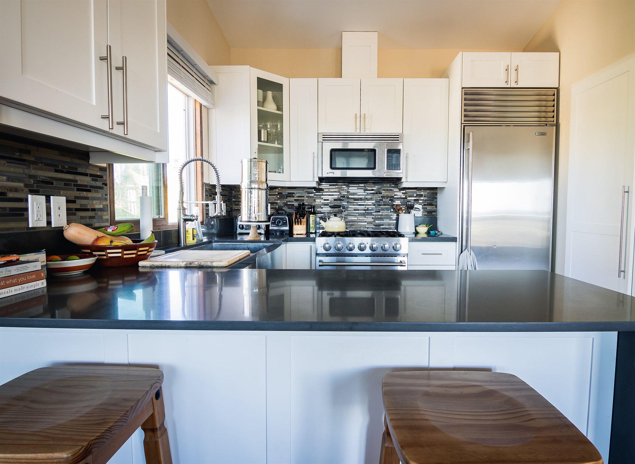 Completed kitchen and dining connection with updated cabinetry and lighting