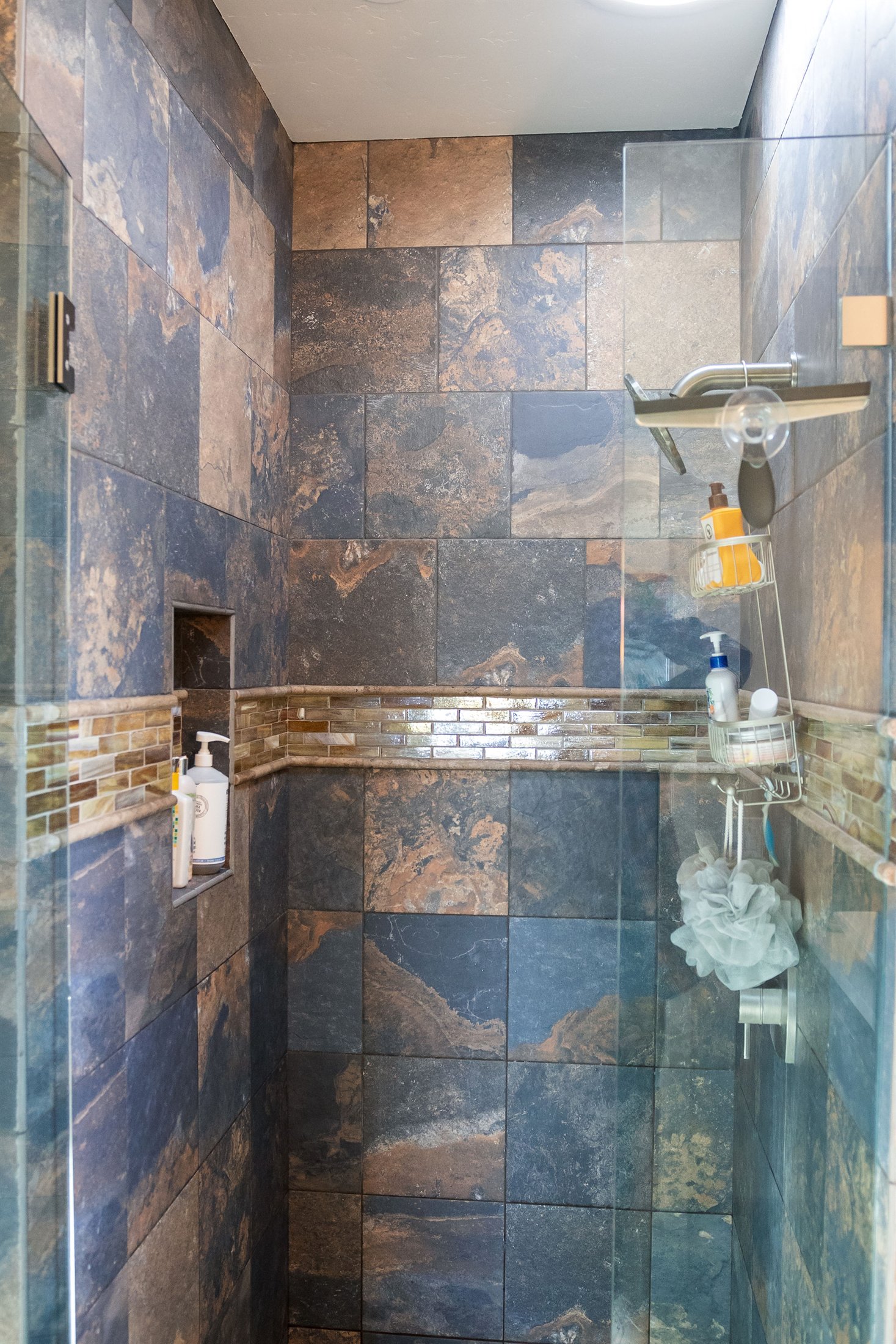 Completed bathroom remodel with coordinated shower tile and vanity finishes