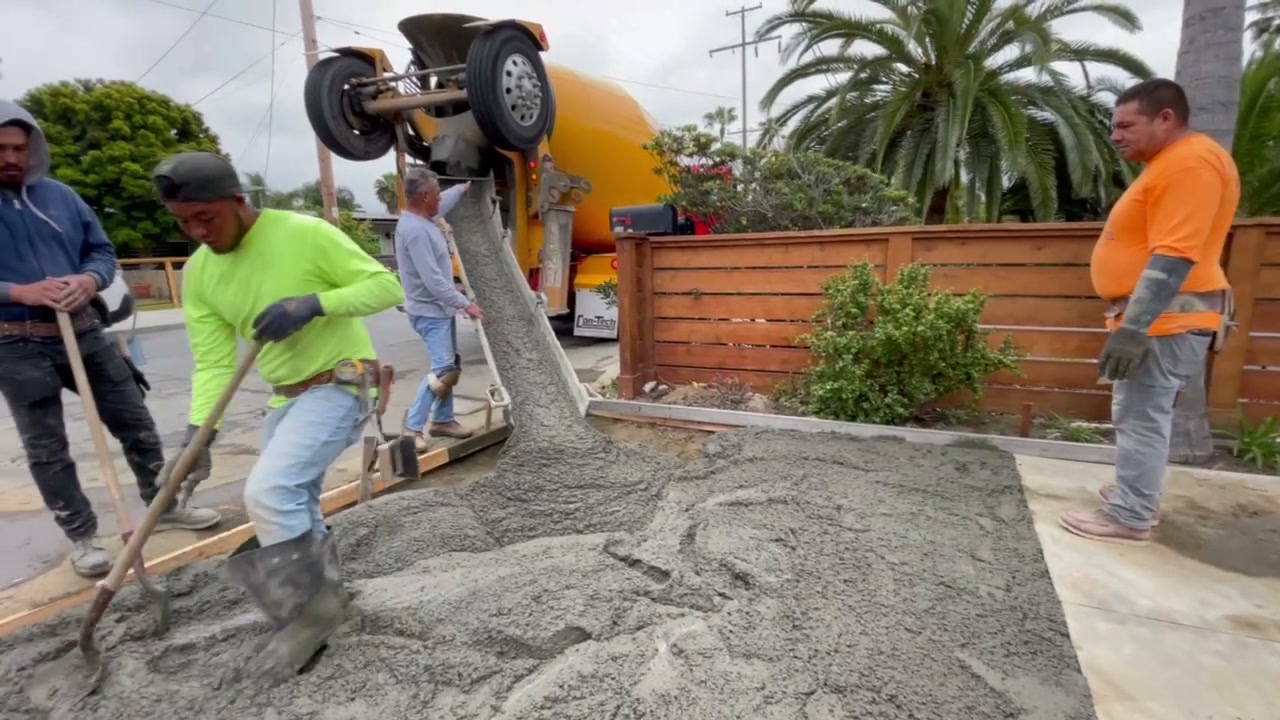 Concrete crew placing and finishing flatwork at the Encinitas ADU
