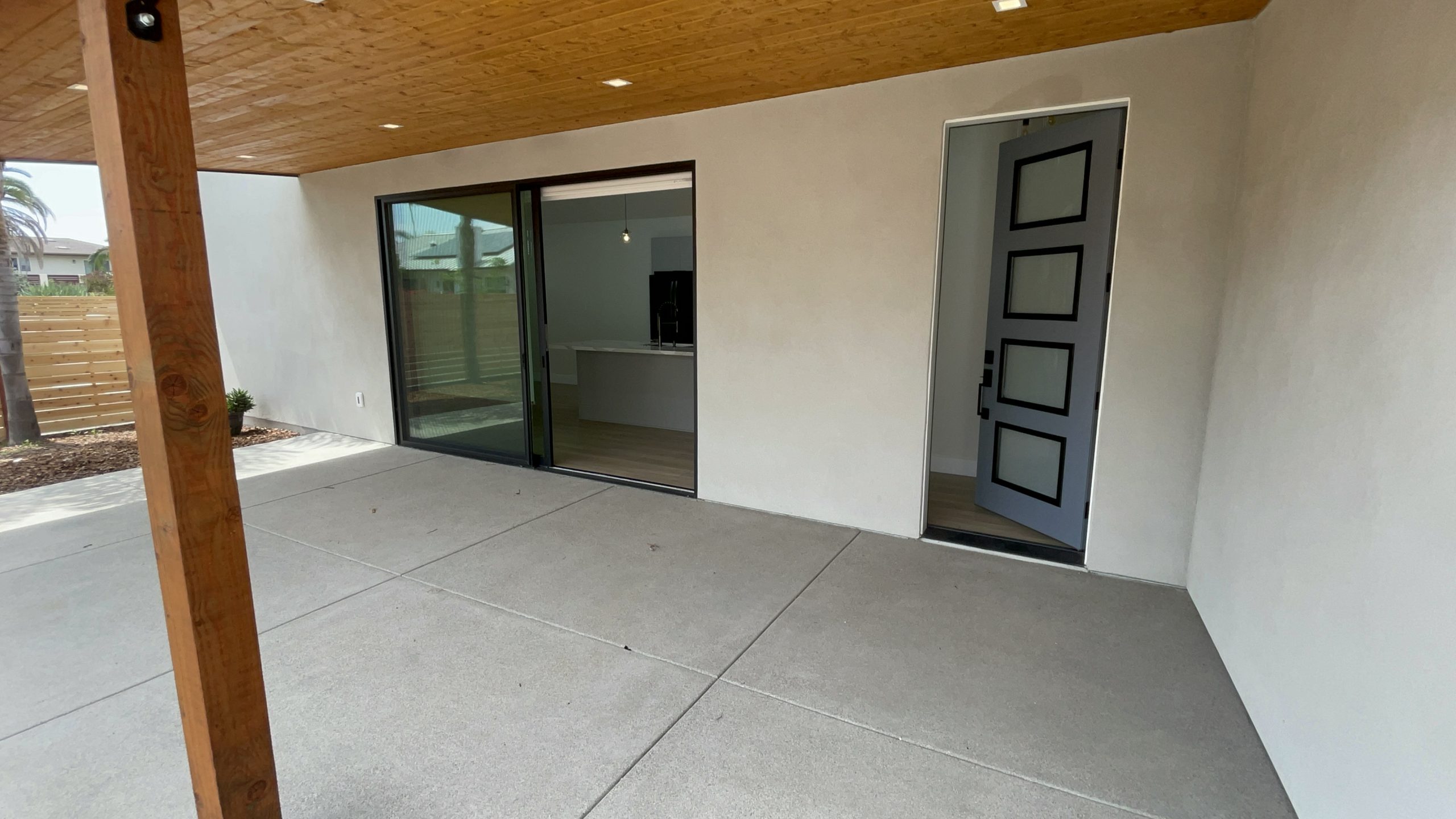 Covered patio and entry at the completed L-shaped ADU in Encinitas