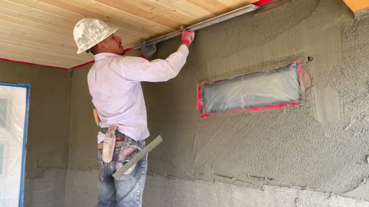 Craftsperson applying exterior stucco during Encinitas ADU construction