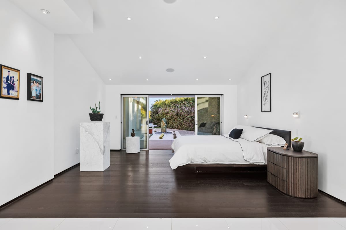 Estrella del Mar remodel: Finished primary bedroom opening toward the garden.